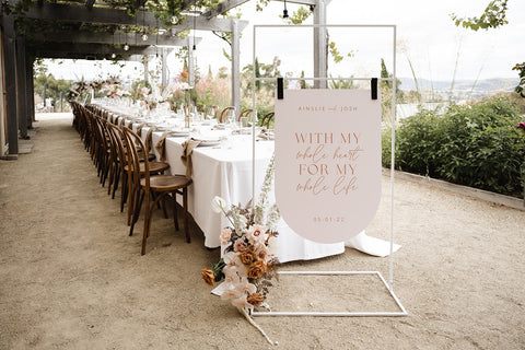 Wedding welcome sign, upside down arch in chai with cinnamon text, at Stefano Lubiana Wines