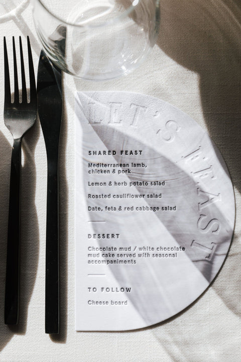 Letterpress white arch wedding menu with black text at Ratho Farm, Hobart