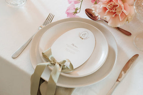 Oval Menu with watercolor monogram and ribbon tied at the bottom in a bow with guests name